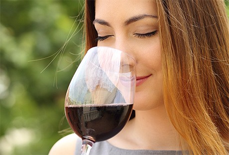 woman sniffing glass of wine